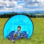 Dziecko siedzące w namiocie na polanie na szlaku żółtym prowadzącym na Żar w Pieninach