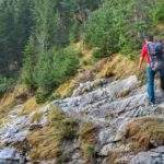 mężczyzna z chłopcem schodzący stromo w dół z Przełęczy Kondrackiej w stronę Małej Łąki
