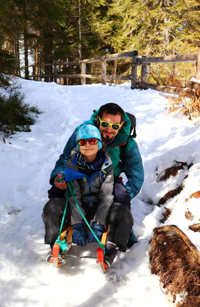 Dziecko z tatą na sankach - żółty szlak na Nosal zimą, leśna ścieżka