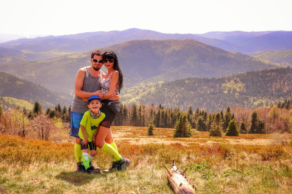 Trzyosobowa, szczęśliwa rodzina (dziecko) na Polanie Stumorgowej, w oddali krajobraz górski