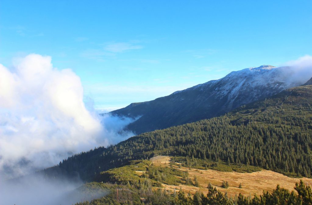 Widok na ośnieżone pasmo Babiej Góry, chmury, szlak na Małą Babią Górę