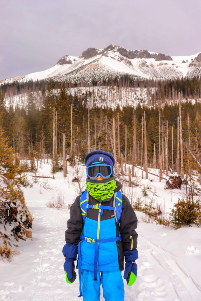Mały turysta - dziecko w goglach, Tatry Słowackie zimą, w tle tatrzańskie szczyty
