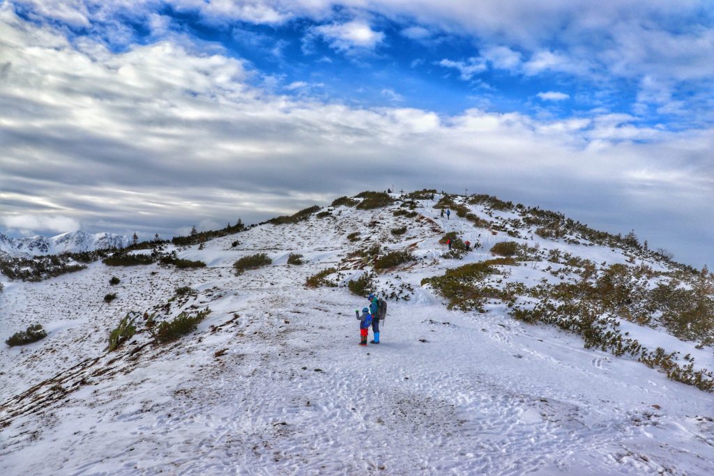 Ostatnie podejście na zaśnieżony szczyt Grześ (szlak żółty), turysta z dzieckiem