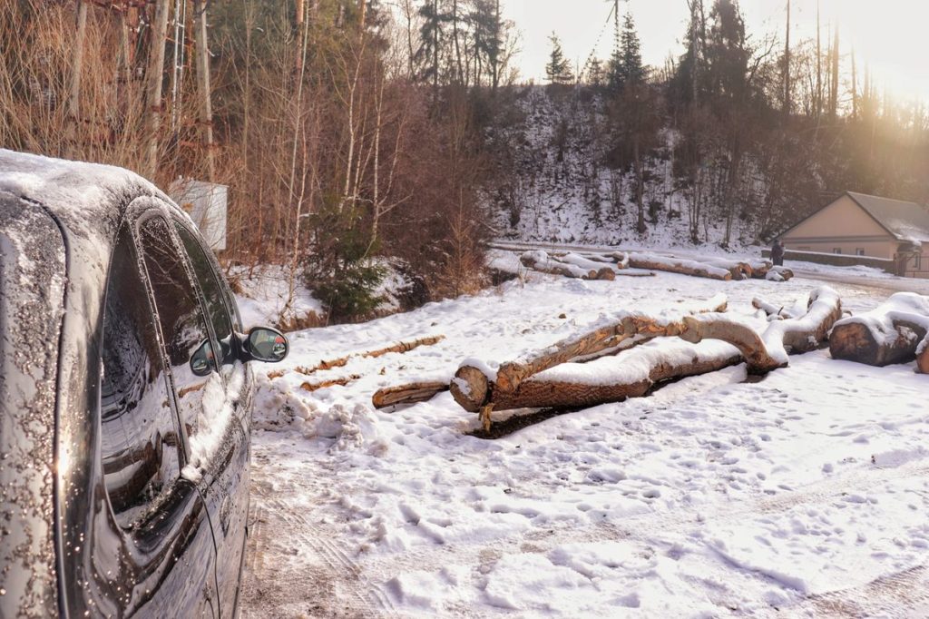 Parking w Rajczy na niebieskiem szlaku na Halę Boraczą, czarny samochód, śnieg, słoneczny poranek