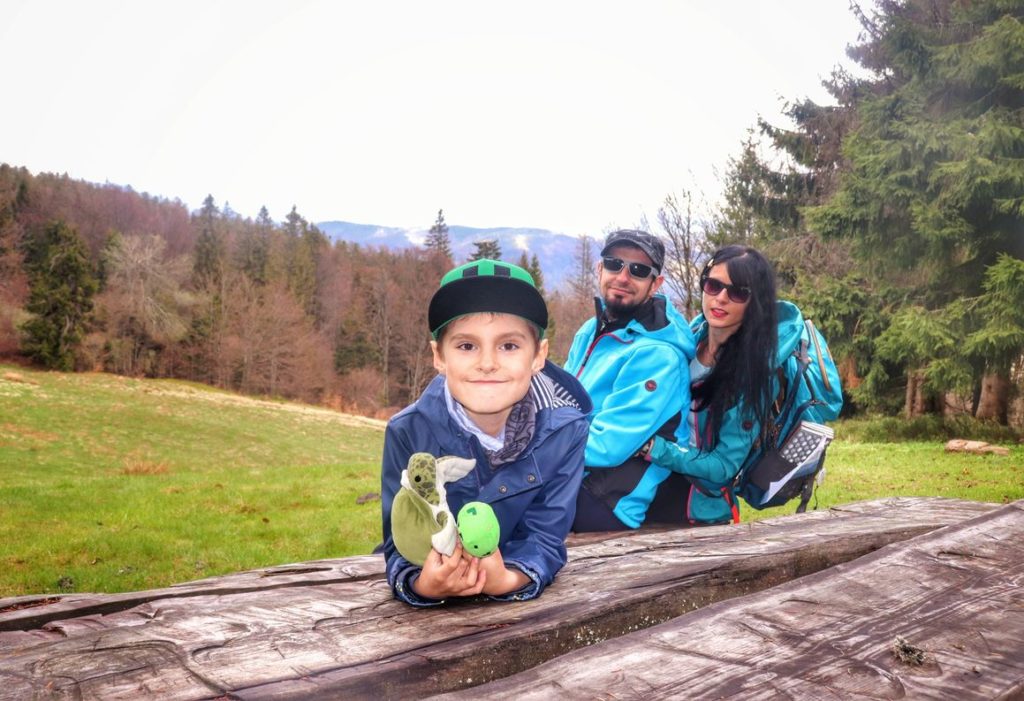 Szczęśliwa rodzina - dziecko z rodzicami na Wielkiej Rycerzowej, drewniany stół