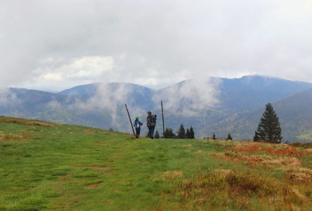Turysta z dzieckiem w drodze do schroniska na Rycerzowej (czarny szlak), krajobraz górski