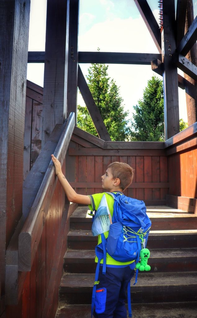 Magurki wieża widokowa w Ochotnicy Dolnej, dziecko wychodzące po schodach na drewnianą wieżę
