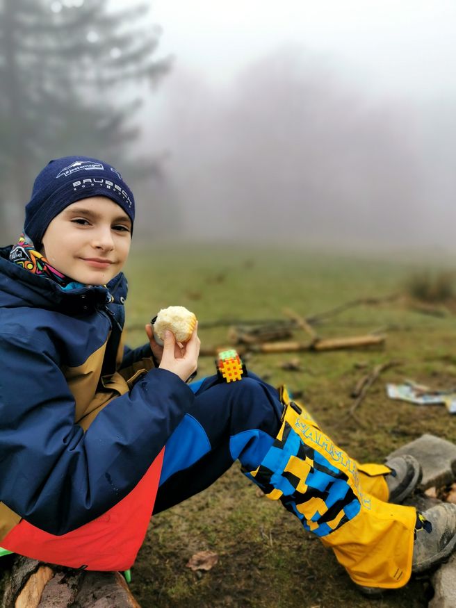 Uśmiechnięte dziecko odpoczywające na szczycie Mała Czantoria w Beskidzie Śląskim, mgliste popołudnie