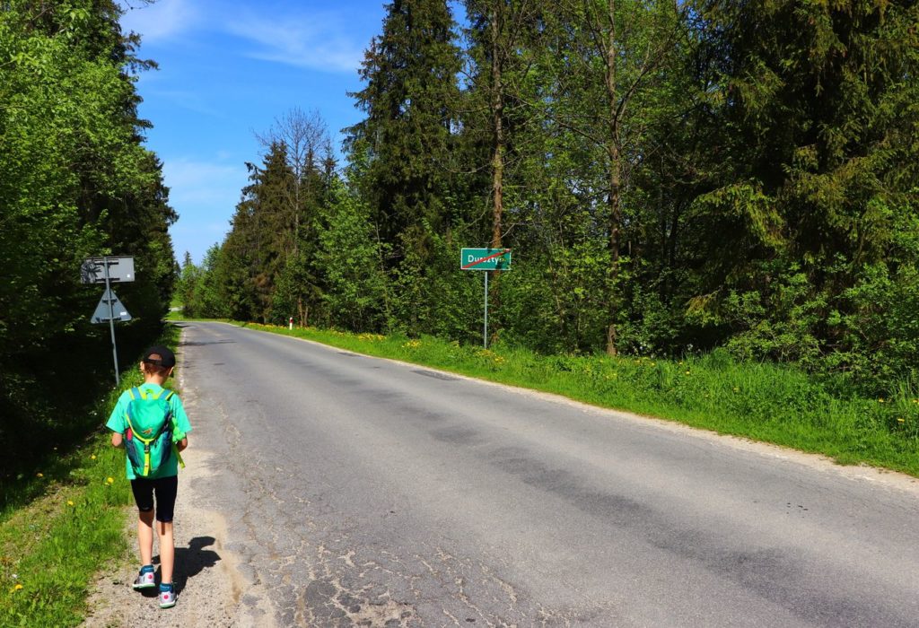 Dziecko idące poboczem drogi w Dursztynie - szlak zielony