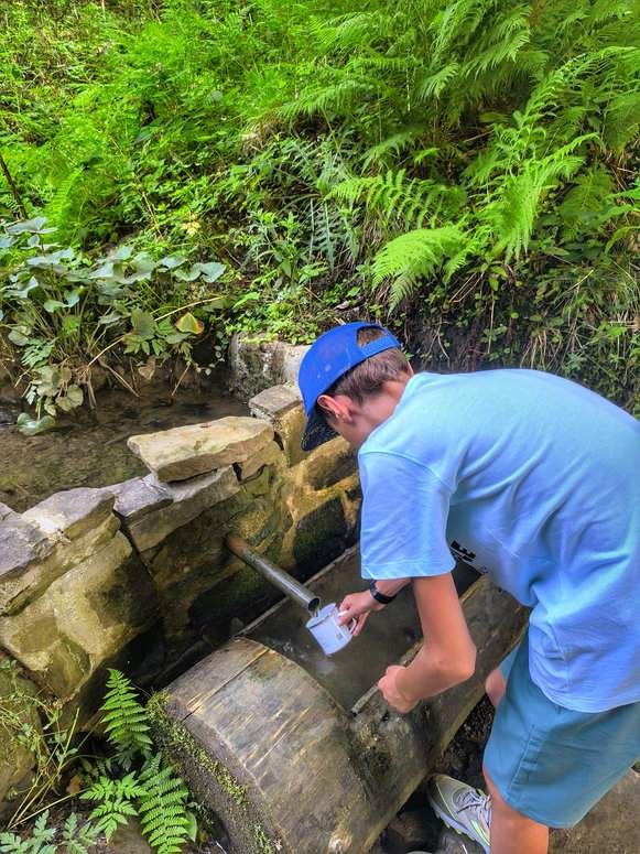 Dziecko z metalowym kubkiem, źródełko górskie na żółtym szlaku, Oszczadnica na Słowacji