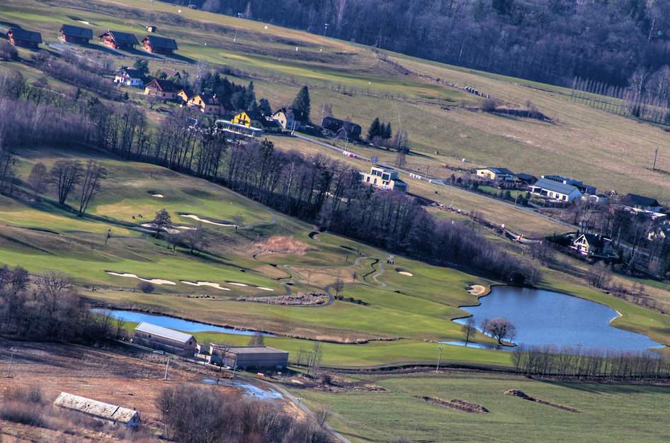 Turysta z dzieckiem na ławeczce podziwia widoki z punktu widokowego na Ostravicę i Ondřejník w Czechach